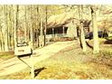 Quaint one-story house with a welcoming porch and a mailbox, framed by mature trees along the driveway at 1409 Keogh St, Burlington, NC 27215