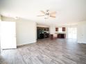 Spacious open-concept living room featuring hardwood floors, ceiling fan, and natural light at 15 Golden Poppy Ln, Youngsville, NC 27596