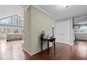 Inviting entryway with brick accent wall, hardwood floors, and views into the brightly lit living spaces at 1965 Wedgewood Dr, Sanford, NC 27332