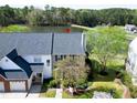 Aerial view of a lovely townhome that backs to a picturesque lake at 200 Nottinghill Walk, Apex, NC 27502