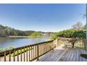 Spacious deck with railing overlooking scenic lake and trees at 200 Nottinghill Walk, Apex, NC 27502