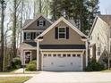 Charming two-story home featuring a two-car garage, well-maintained lawn, and beautiful curb appeal at 2217 Magnolia Tree Ln, Durham, NC 27703