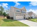 Two-story home featuring a large driveway and well-maintained lawn at 245 Naples Ln, Clayton, NC 27527