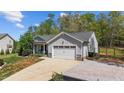Beautifully landscaped home with a well-maintained lawn, driveway, and attached two car garage at 25 S Treeline Dr, Spring Hope, NC 27882