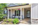 Inviting front porch with seating, decorative plants, and a charming entrance for a welcoming appeal at 25 S Treeline Dr, Spring Hope, NC 27882