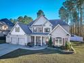 Charming two-story home with a manicured lawn, two-car garage, inviting entrance, and lush landscaping at 286 Sea Mist Dr, Sanford, NC 27332