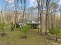 Beautiful two-story home surrounded by trees, offering a sense of privacy and seclusion at 323 E Stratford Dr, Henderson, NC 27537