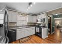 Practical kitchen features white cabinets, modern appliances, and ample countertop space at 323 E Stratford Dr, Henderson, NC 27537
