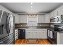 Functional kitchen with stainless steel appliances and white cabinetry at 323 E Stratford Dr, Henderson, NC 27537