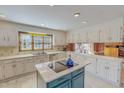 Bright kitchen with white cabinets, stainless steel appliances, a blue island, and ample counter space at 382 Wimbledon Dr, Roxboro, NC 27573