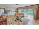 Comfortable living room with hardwood floors, a plush sofa, and sliding glass doors to the backyard at 382 Wimbledon Dr, Roxboro, NC 27573