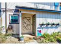 Street view of the front entrance featuring flowerpots and creative front door decor at 3923 Wendy Ln, Raleigh, NC 27606