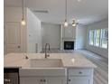 Bright kitchen with an island with sink, stainless steel appliances, and views into the living room at 4012 Kingcraig Ln, Zebulon, NC 27597