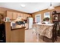 Cozy kitchen with natural wood cabinets and dining area, perfect for Gathering meals at 4118 Sudbury Rd, Durham, NC 27704