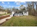 Charming home exterior featuring a covered front porch and manicured front lawn at 4509 Alamance Baptist Church Loop, Burlington, NC 27215