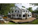 Exterior view of new house construction featuring a modern design, brick foundation and large windows at 5107 Hearth Dr, Raleigh, NC 27609