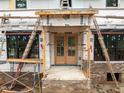 A new construction home with beautiful double doors framed by a brick base and supported by ladders at 5107 Hearth Dr, Raleigh, NC 27609