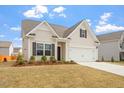 Charming home with a well-manicured lawn and attached two-car garage at 5205 Sorrell Glen Dr, Raleigh, NC 27603