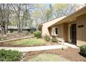 The property offers a well-maintained lawn, mature trees, and a neatly landscaped area along the side at 716 Red Forest Trl, Raleigh, NC 27615