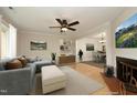Cozy living room with ceiling fan, plush seating, and view into the adjacent dining area at 716 Red Forest Trl, Raleigh, NC 27615