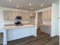 Modern kitchen showcasing stainless steel appliances, a center island, and stylish cabinets at 75 Furley St., Homesite 115, Sanford, NC 27330