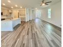 Open concept living room and kitchen area with hardwood floors and plenty of natural light at 75 Furley St., Homesite 115, Sanford, NC 27330