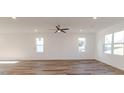 Bright living room featuring beautiful wood floors, neutral walls, and a modern ceiling fan at 75 Furley St., Homesite 115, Sanford, NC 27330