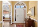 Bright foyer features arched doorway, wood floors, and elegant decor at 805 Lee St, Gibsonville, NC 27249