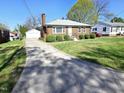 Charming brick home featuring a long driveway and detached garage at 807 Everett St, Burlington, NC 27215
