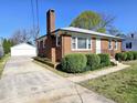Traditional brick home with a detached garage and a long driveway at 807 Everett St, Burlington, NC 27215