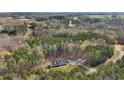 An aerial view of a secluded home surrounded by lush greenery and mature trees offering privacy at 90 Ferncrest Ct, Roxboro, NC 27574