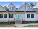 Attractive exterior displaying blue front door flanked by windows, flower boxes, and complementary landscape design at 90 Ferncrest Ct, Roxboro, NC 27574