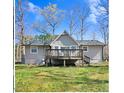 Back of home featuring a wooden deck overlooking the spacious backyard at 908 Snow Hill Rd, Durham, NC 27712