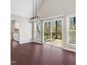 Bright dining room with hardwood floors, large windows, and deck access at 908 Snow Hill Rd, Durham, NC 27712