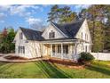 Stunning two-story home with a well-maintained lawn and a charming front porch at 924 Elbridge Dr, Raleigh, NC 27603