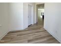 A light and airy hallway boasts sleek wood floors and neutral paint, creating a modern feel at 93 Steel Springs Ln, Angier, NC 27501
