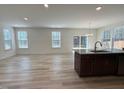 The spacious living room flows into the kitchen, creating an open and inviting floor plan at 93 Steel Springs Ln, Angier, NC 27501