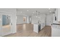 Open kitchen showcasing stainless steel appliances, light countertops and adjacent living space at 1009 Shovelhead Dr # 5, Durham, NC 27703