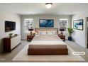 Beautiful staged bedroom with a large bed, nightstands, lamps, and decorative wall art at 106 Canvasback Dr, Durham, NC 27704