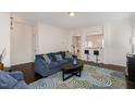 Cozy living room featuring a blue sofa, a colorful rug, and an open layout at 110 White Burley Ct, Durham, NC 27703