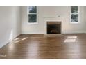 Bright living room featuring hardwood floors and a brick fireplace, ready for personalization at 112 Old Bridge Ln, Chapel Hill, NC 27517