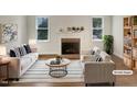 Bright living room with a brick fireplace, sleek furniture, and neutral color palette at 112 Old Bridge Ln, Chapel Hill, NC 27517