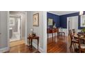 Interiors showing hardwood floors, neutral paint, and a glimpse into a room painted with a blue color palette at 1417 Hathaway Rd, Raleigh, NC 27608