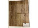 Sample of luxury vinyl tile flooring in a wood-grain finish with product details at 15 Atherton Circle, Angier, NC 27501