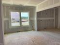Unfinished room ready for personalization, featuring drywall and natural light through a double hung window at 15 Atherton Circle, Angier, NC 27501