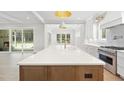 Bright kitchen featuring granite countertop, stainless steel appliances, and access to sunroom at 1520 Lake Adventure Ct, Raleigh, NC 27613