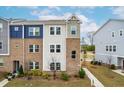 Attractive townhome featuring brick accents, varied siding and a well-maintained front yard at 1613 Clayfire Dr, Cary, NC 27519