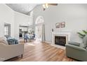 Bright living room boasts vaulted ceilings, a fireplace, hardwood floors, and an open floor plan at 200 Adefield Ln, Holly Springs, NC 27540