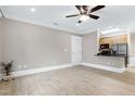 Open-concept space with light wood flooring, a ceiling fan, and access to the kitchen area at 217 Waterford Lake Dr, Cary, NC 27519
