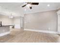 Open-concept with light wood flooring and white trim with view to dining area at 217 Waterford Lake Dr, Cary, NC 27519